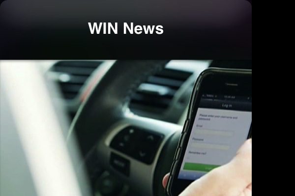 Image of person catching a phone in hand in a car