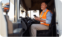 truck driver sitting in a truck with a phone in hand